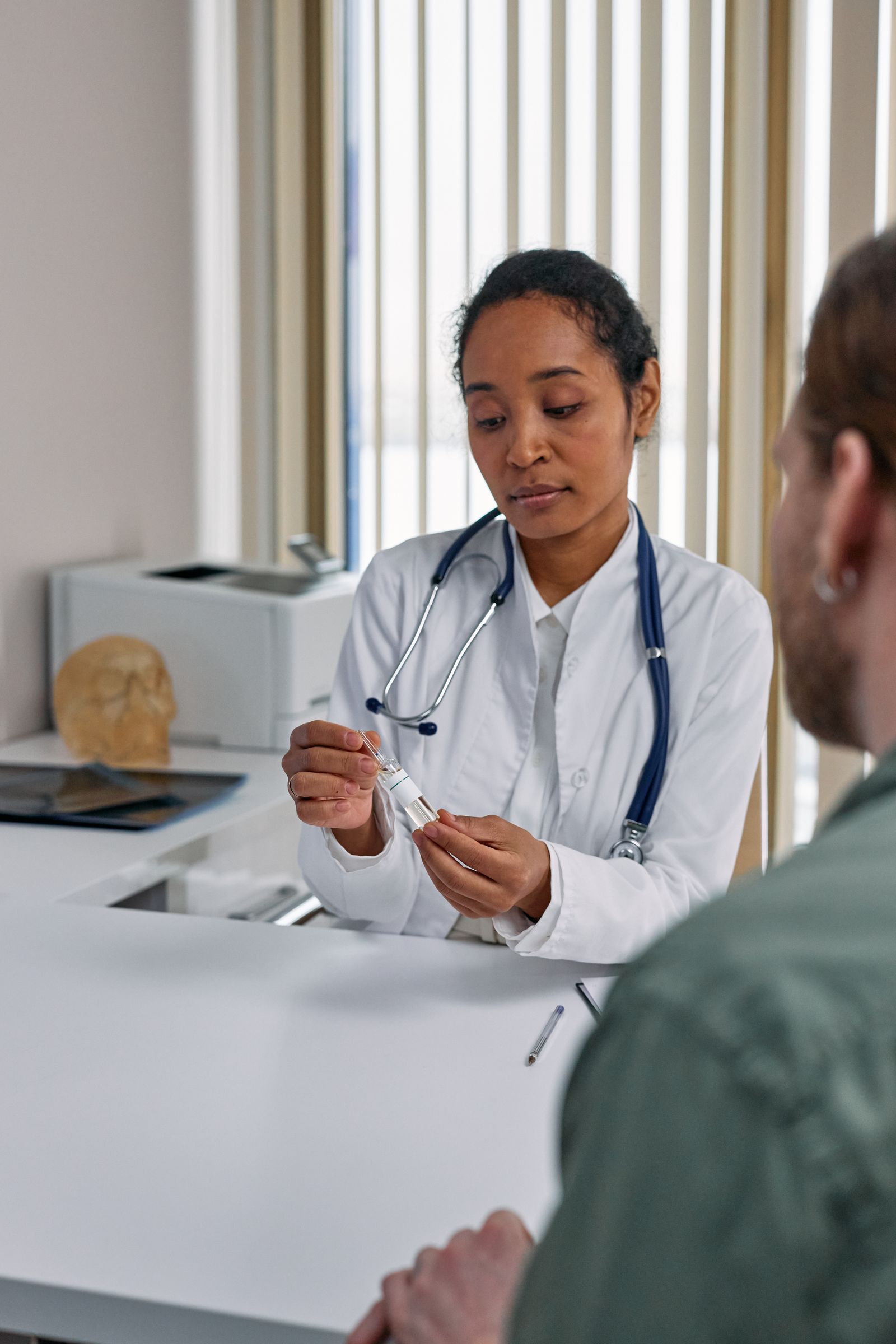 Doctor reviewing something closely with a patient