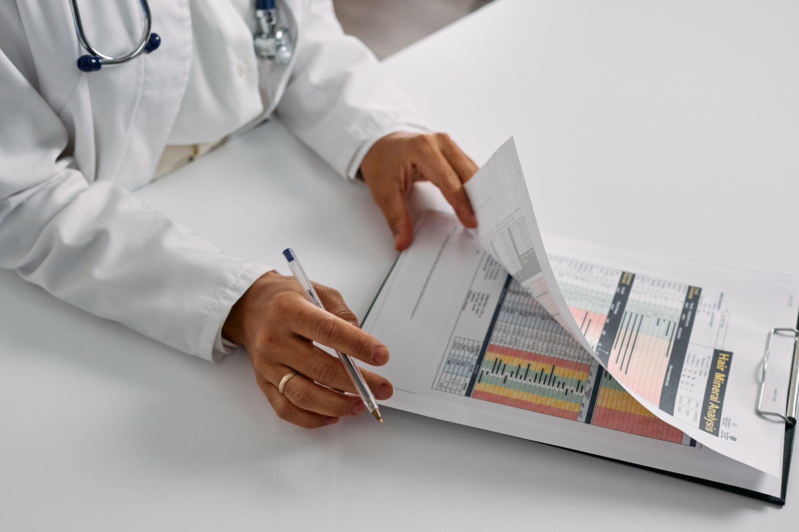 Doctor's hands reviewing a colorful health report closely