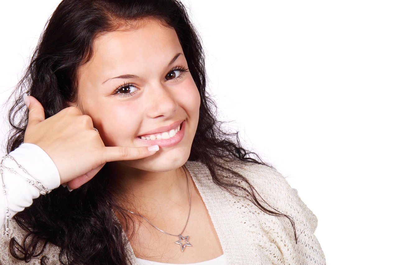 A woman smiling while making a phone call at home