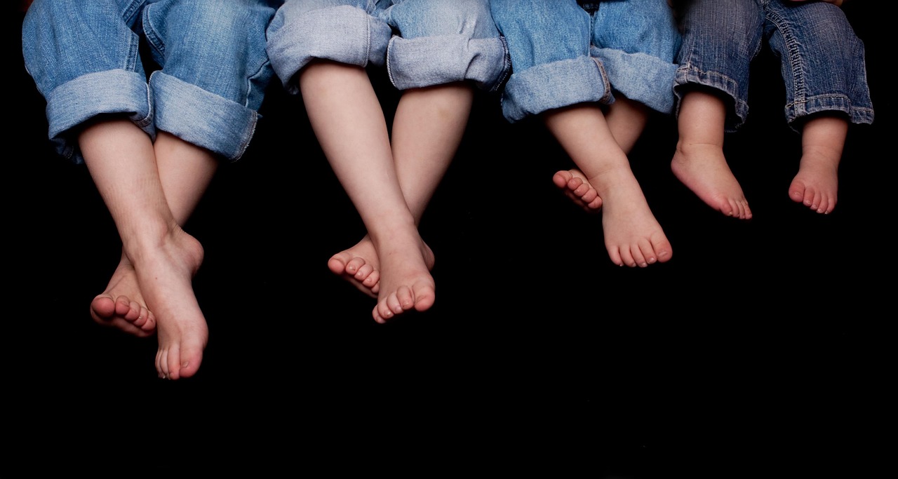 A happy family with young children relaxing together on a couch at home