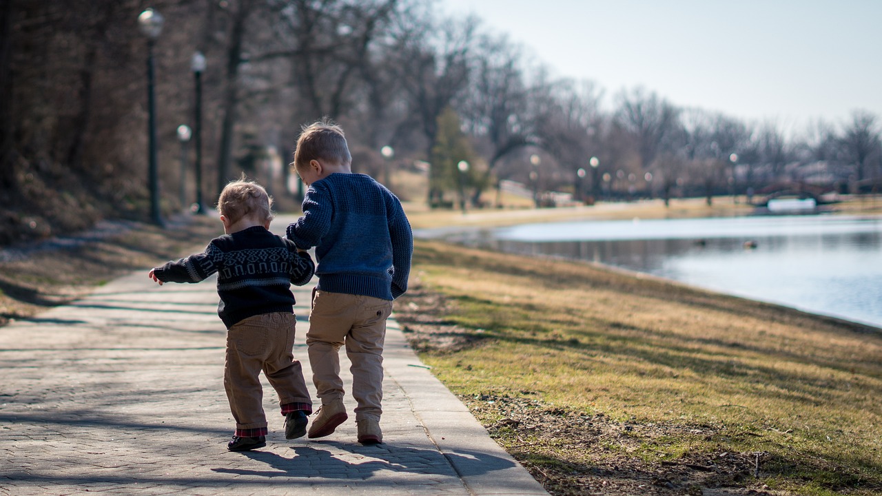 A happy family with young children walking together in a park on a fall day