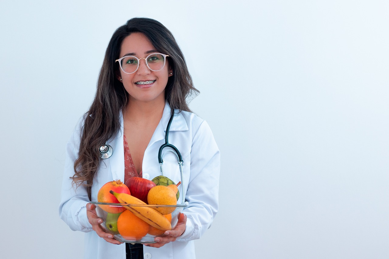 A friendly doctor talking with a young woman during a checkup in a bright clinic