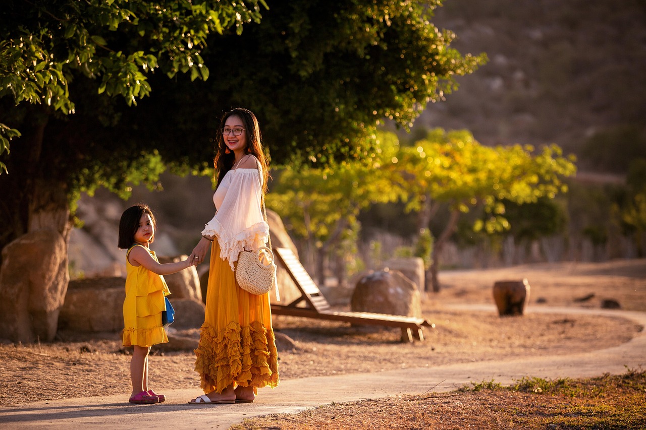 A family with children walking together through a park in autumn