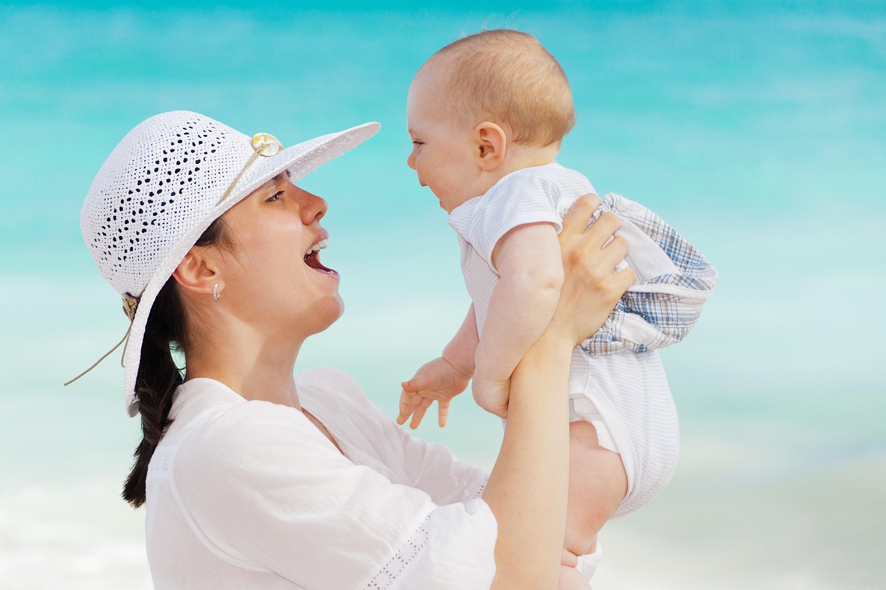 A happy family with parents and children smiling together outdoors on a sunny day