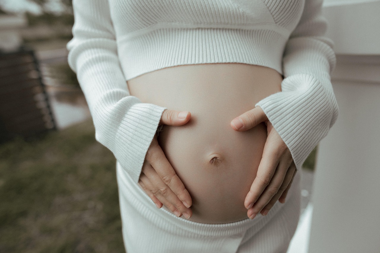 A friendly doctor talking with a pregnant woman during a routine checkup