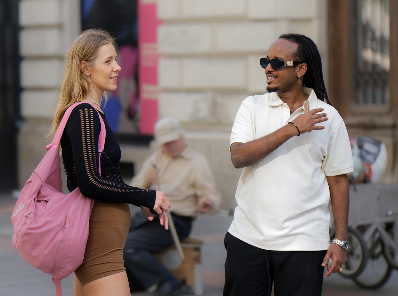 A friendly advisor talking with a woman across a table in a relaxed meeting